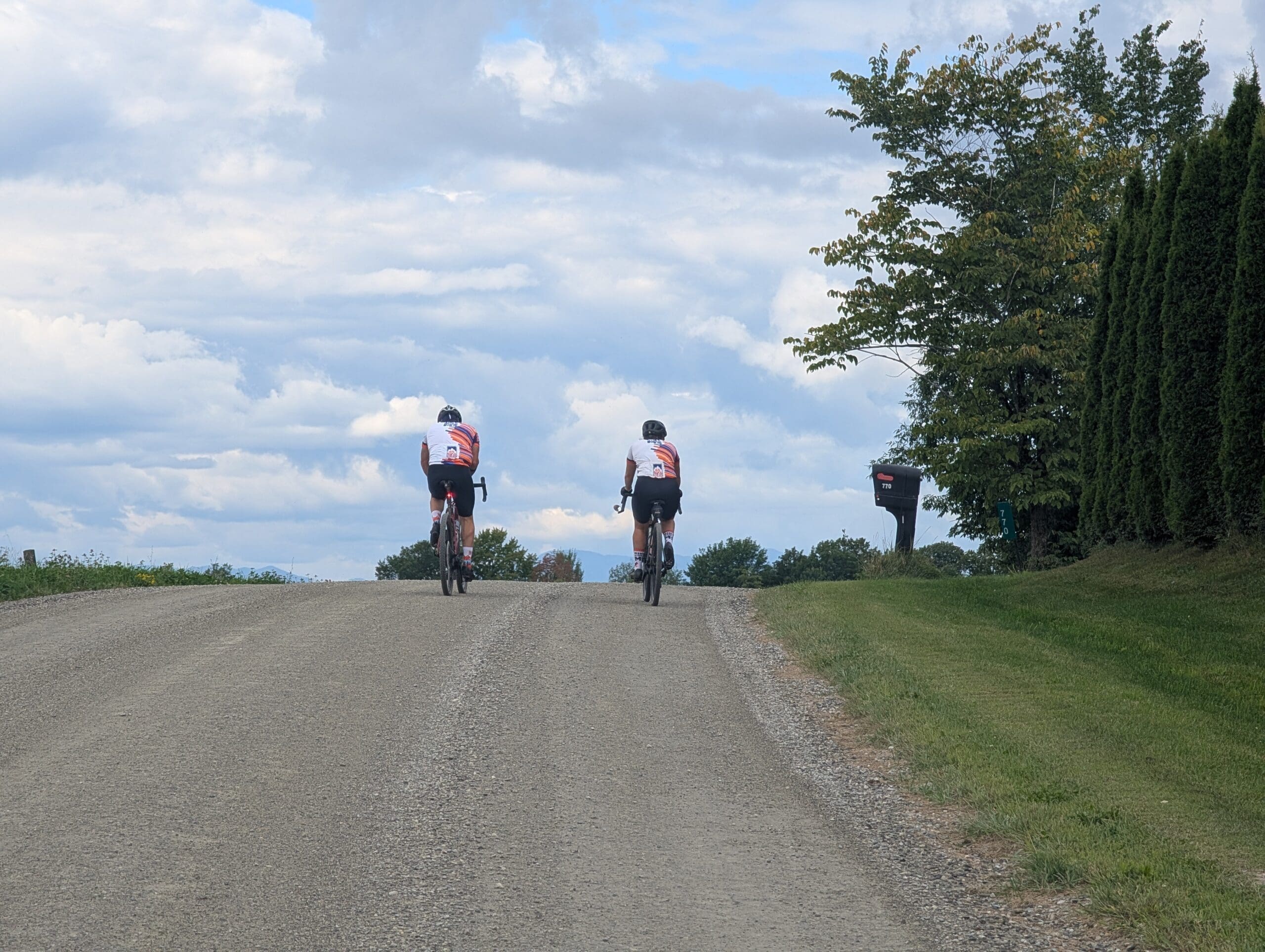 Two Bike the US cyclists cycling on gravel road on the Vermont Gravel cycle